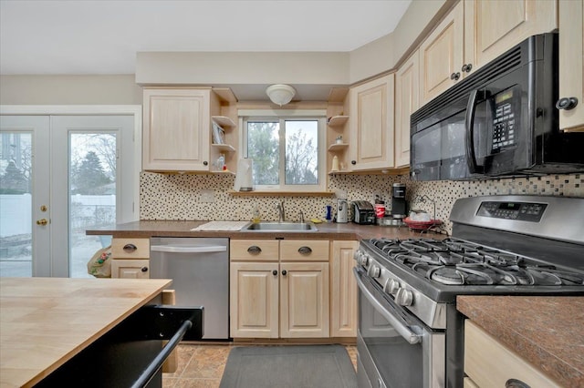 kitchen featuring sink, french doors, wood counters, tasteful backsplash, and appliances with stainless steel finishes