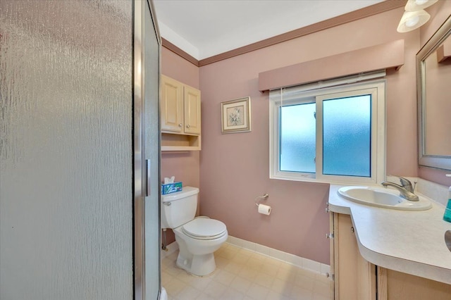 bathroom with vanity, toilet, and crown molding