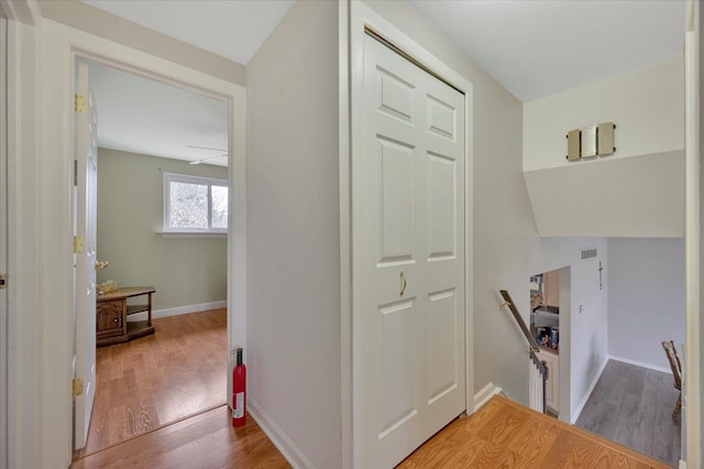 hall with wood-type flooring