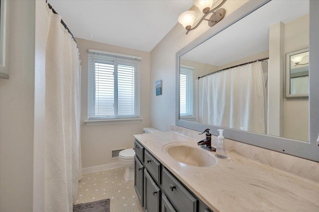 bathroom featuring tile patterned flooring, vanity, and toilet