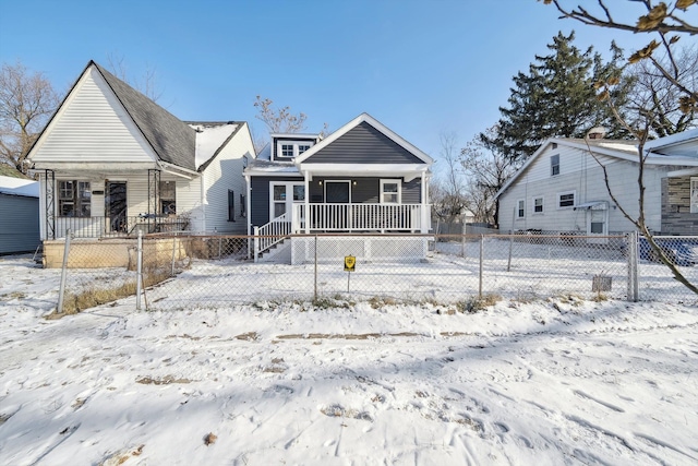 snow covered property featuring a porch