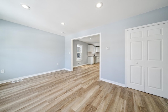 spare room with light hardwood / wood-style flooring and sink