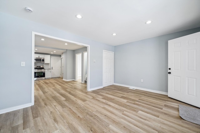 unfurnished living room with light wood-type flooring