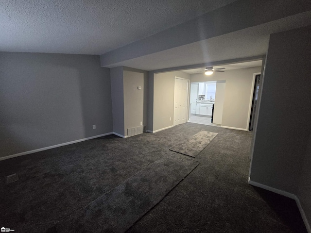 interior space featuring ceiling fan and a textured ceiling