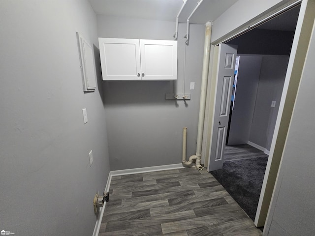 laundry area featuring dark wood-type flooring