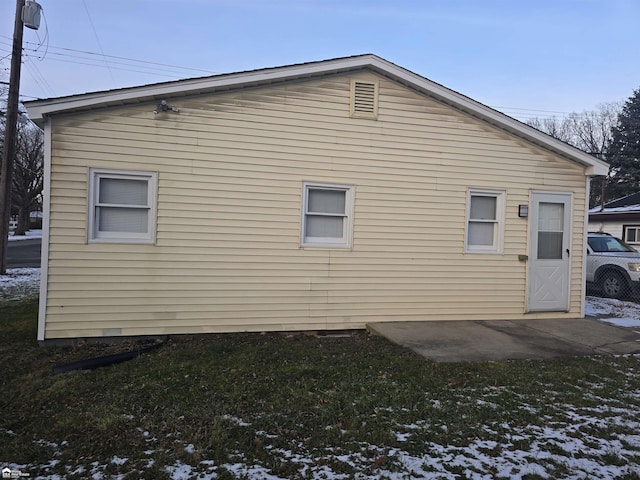 view of snow covered exterior featuring a yard