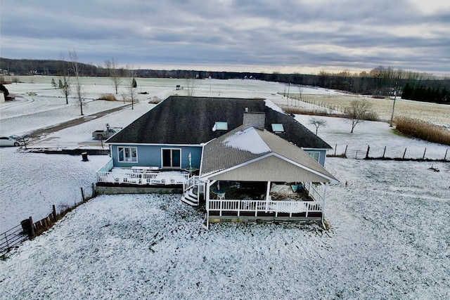 snowy aerial view featuring a rural view