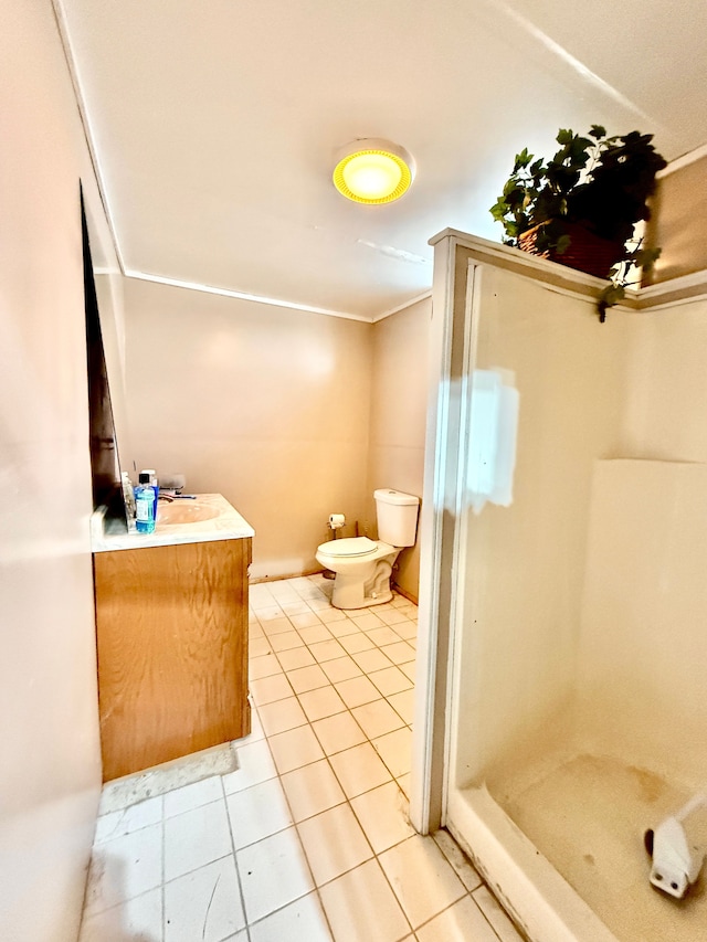 bathroom featuring vanity, tile patterned flooring, toilet, and a shower stall