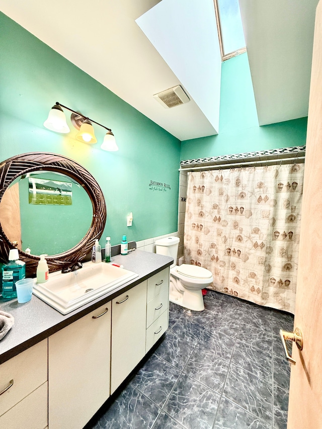 bathroom featuring vanity, curtained shower, and toilet