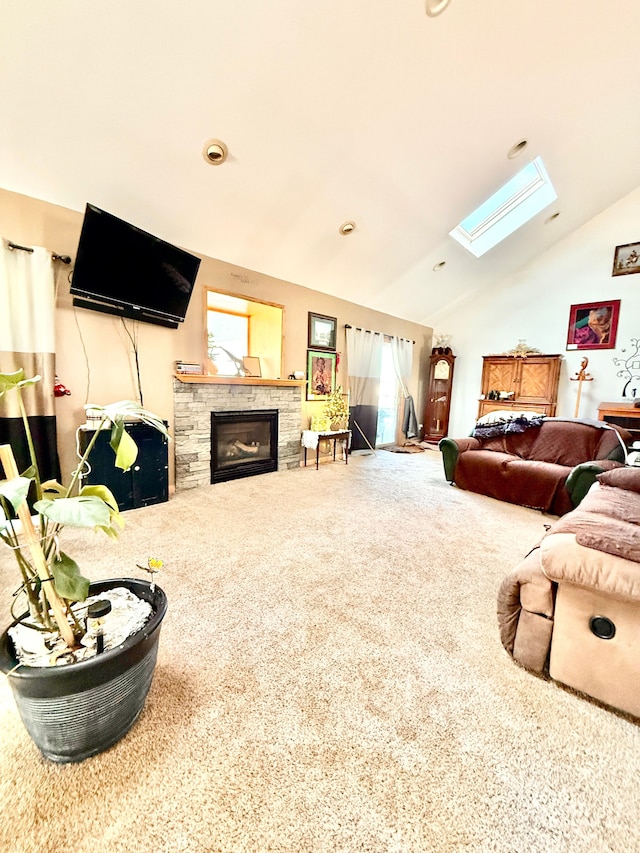 living room featuring vaulted ceiling with skylight, a fireplace, and carpet flooring