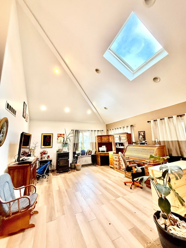 misc room featuring high vaulted ceiling, light wood-style flooring, recessed lighting, a skylight, and visible vents