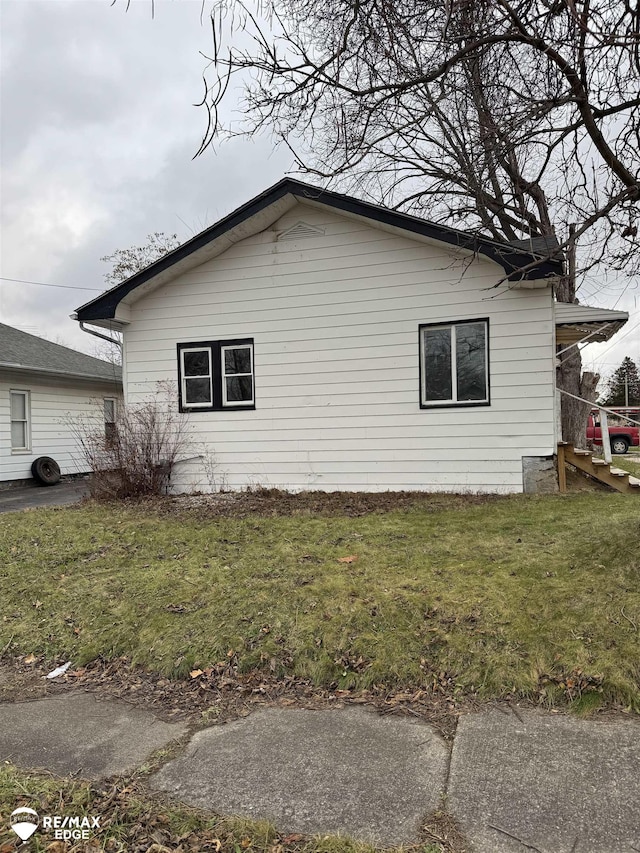 view of side of property with a lawn