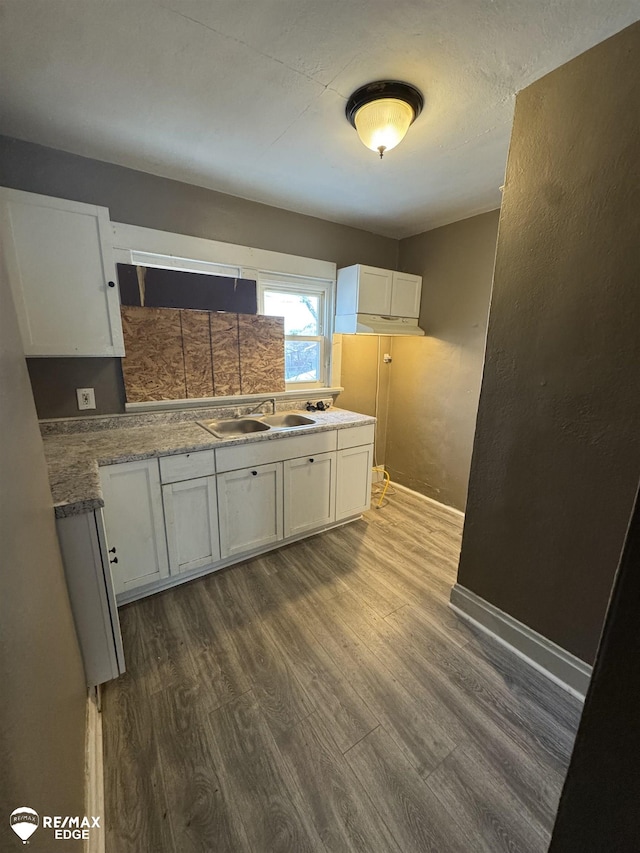 kitchen featuring white cabinets, dark wood-type flooring, and sink