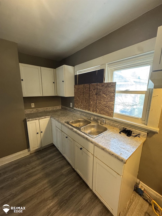 kitchen with white cabinetry, sink, and dark wood-type flooring