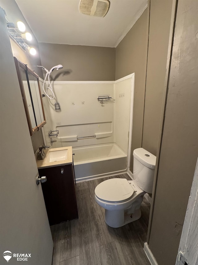 full bathroom featuring bathing tub / shower combination, vanity, hardwood / wood-style flooring, and toilet