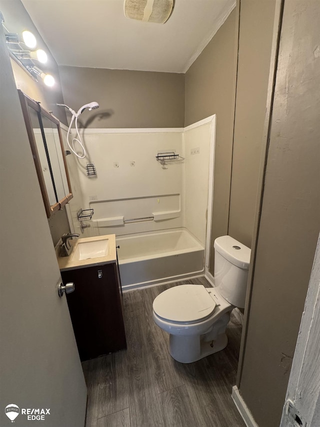 full bathroom with shower / tub combination, vanity, hardwood / wood-style flooring, and toilet