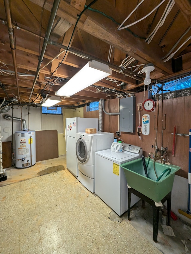 washroom featuring electric panel, water heater, sink, and separate washer and dryer