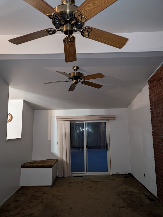 carpeted empty room with ceiling fan and vaulted ceiling