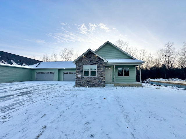 view of front of home with a garage, stone siding, and covered porch