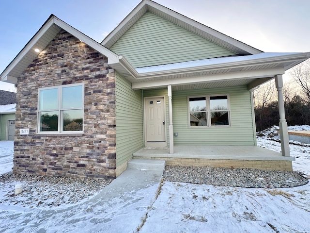 view of front facade featuring covered porch and stone siding