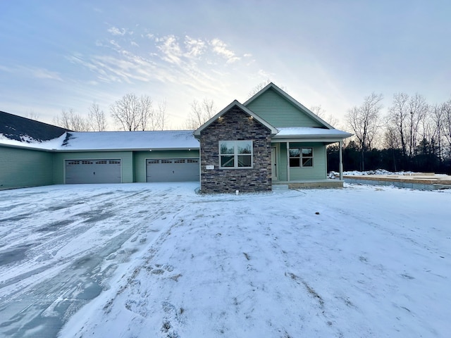 view of front of house with stone siding, covered porch, and an attached garage