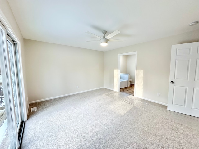 unfurnished bedroom featuring a ceiling fan, carpet, visible vents, and baseboards