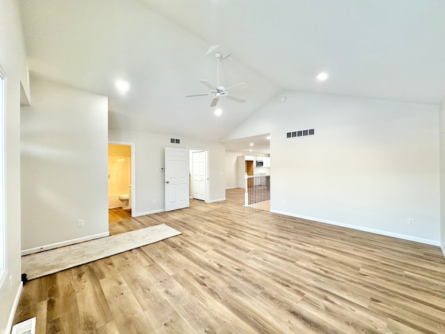 interior space featuring ceiling fan, high vaulted ceiling, visible vents, baseboards, and light wood finished floors