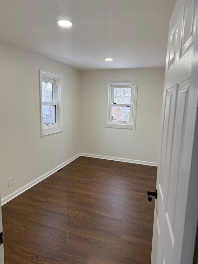 empty room featuring dark wood-type flooring