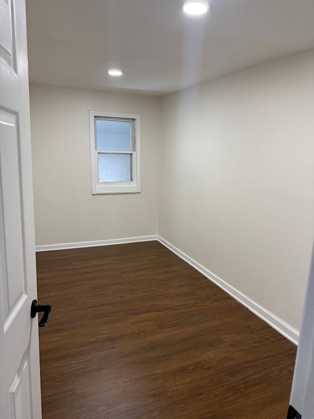 unfurnished room featuring dark hardwood / wood-style flooring