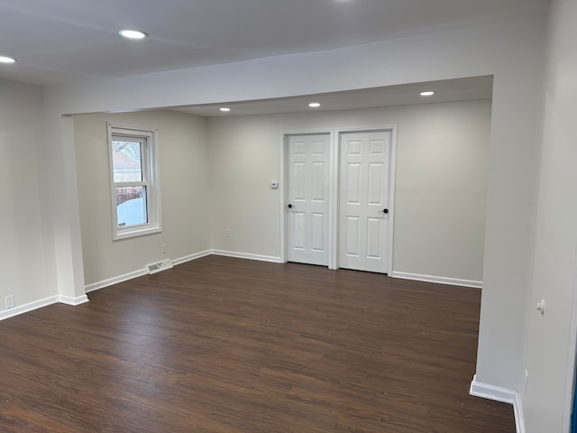 empty room with dark wood-type flooring