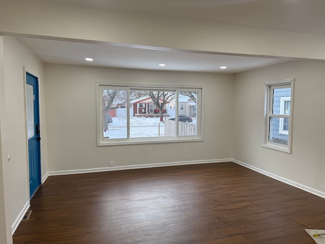 spare room featuring dark hardwood / wood-style floors