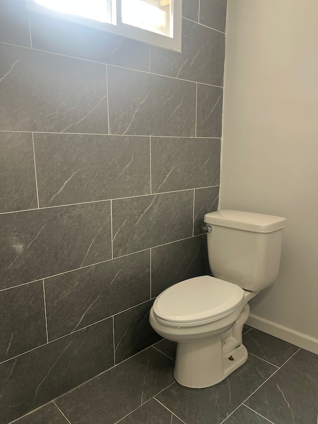 bathroom featuring tile patterned flooring and toilet