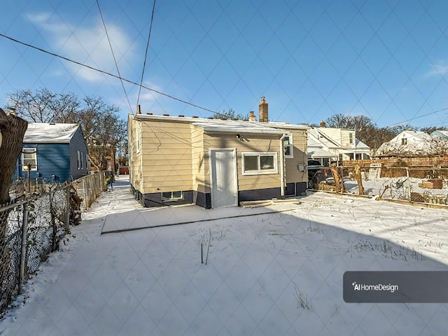 view of snow covered back of property