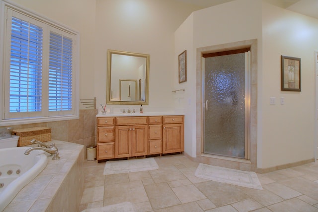 bathroom with tile patterned floors, plus walk in shower, and vanity