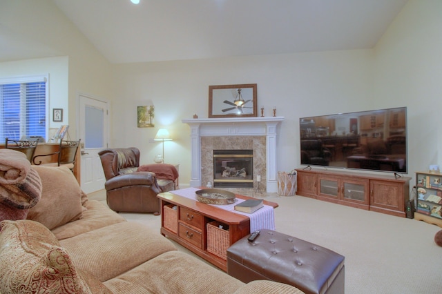 living room with a high end fireplace, light colored carpet, ceiling fan, and lofted ceiling