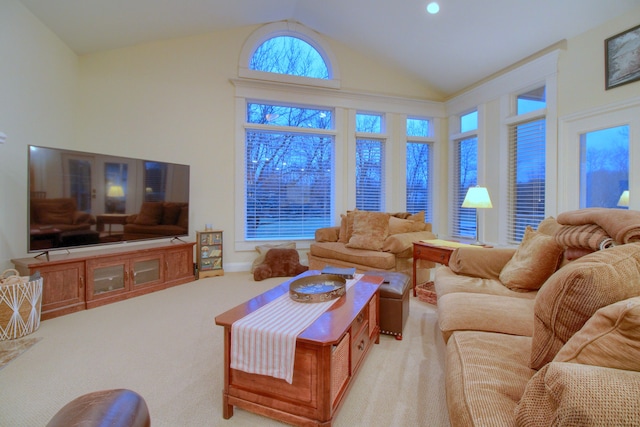 carpeted living room featuring high vaulted ceiling