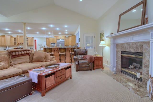 living room featuring a high end fireplace, light colored carpet, and high vaulted ceiling