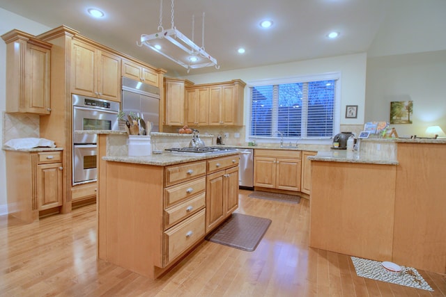 kitchen featuring light stone counters, light brown cabinets, light hardwood / wood-style floors, and appliances with stainless steel finishes