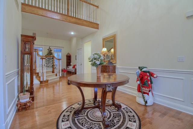 foyer entrance featuring a high ceiling and light hardwood / wood-style floors