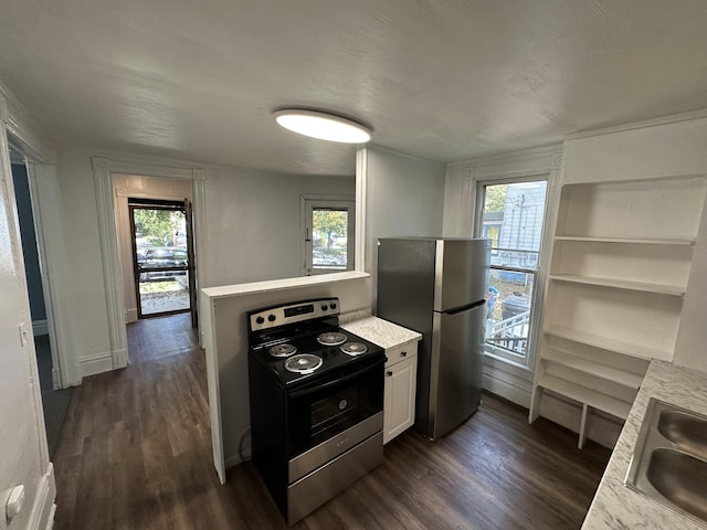 kitchen with a healthy amount of sunlight, white cabinetry, and appliances with stainless steel finishes