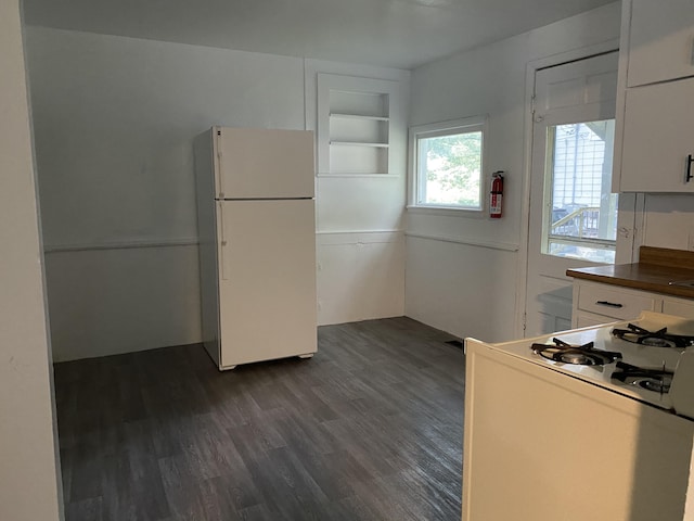 kitchen featuring white cabinets, white appliances, and dark wood-type flooring