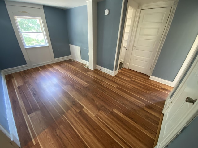 unfurnished room featuring dark hardwood / wood-style floors