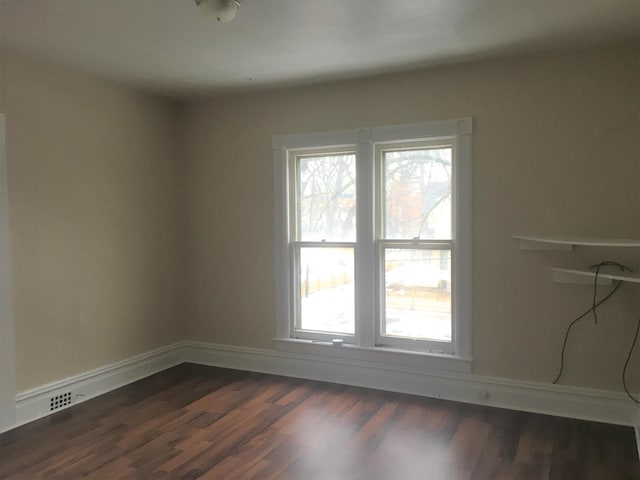 empty room with dark wood-type flooring