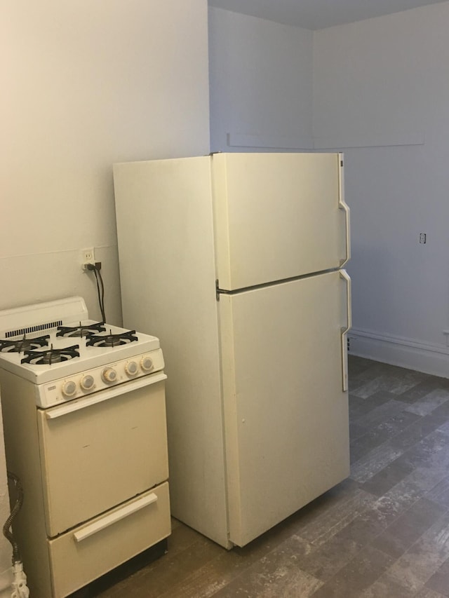 kitchen featuring white appliances and dark wood-type flooring