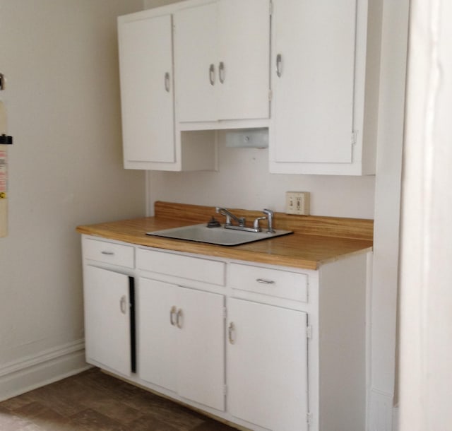 kitchen featuring white cabinets and sink