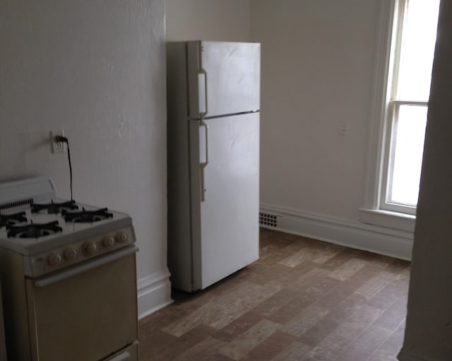 kitchen with wood-type flooring and white appliances