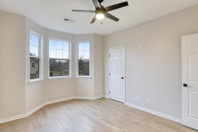 empty room with light hardwood / wood-style flooring and ceiling fan