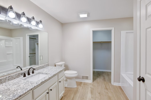 bathroom featuring hardwood / wood-style floors, vanity, and toilet