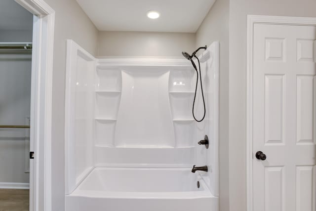 bathroom with wood-type flooring and shower / bath combination