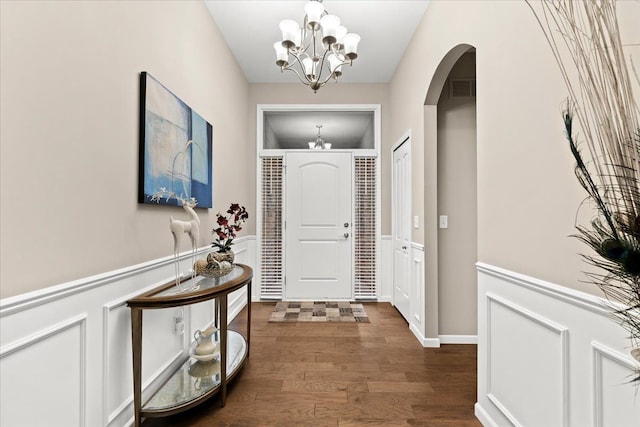 entrance foyer with dark wood-type flooring and a chandelier